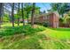 Traditional brick home surrounded by mature trees and lush landscaping on a large lot at 4590 Sims Ct, Tucker, GA 30084