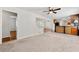 Open-concept living and dining area with seamless flow, neutral paint and light fixtures at 4590 Sims Ct, Tucker, GA 30084