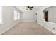 Spacious room featuring neutral carpet, paint and ceiling fan and adjoining rooms at 4590 Sims Ct, Tucker, GA 30084