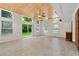 Bright living room with a wood ceiling, tile floors, and sliding glass doors to the backyard at 4590 Sims Ct, Tucker, GA 30084