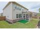 Spacious backyard with a fenced-in yard, lush grass, basketball hoop, and covered patio, ideal for outdoor activities at 688 Saffron Blvd, Lawrenceville, GA 30045