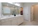 Elegant bathroom with dual sinks, a large mirror, and modern fixtures at 688 Saffron Blvd, Lawrenceville, GA 30045