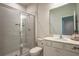 Bathroom features a glass shower and white cabinets at 688 Saffron Blvd, Lawrenceville, GA 30045