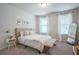 Bright bedroom with neutral decor, large windows, and elegant furniture at 688 Saffron Blvd, Lawrenceville, GA 30045