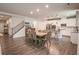 Open-concept dining room and kitchen area featuring hardwood floors, stainless steel appliances, and a staircase at 688 Saffron Blvd, Lawrenceville, GA 30045