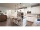 Bright, open kitchen with white cabinets, stainless steel appliances, and a large island with marble countertops at 688 Saffron Blvd, Lawrenceville, GA 30045