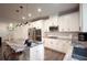 Bright open kitchen showcasing stainless appliances, white cabinetry and modern hardware at 688 Saffron Blvd, Lawrenceville, GA 30045