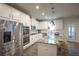 Bright kitchen with stainless steel appliances, marble countertops, and white cabinets at 688 Saffron Blvd, Lawrenceville, GA 30045