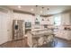 Modern kitchen featuring white cabinets, stainless steel appliances, granite countertops, and a center island at 688 Saffron Blvd, Lawrenceville, GA 30045