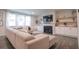Inviting living room with plush sectional sofa, fireplace, built-ins, and lots of natural light at 688 Saffron Blvd, Lawrenceville, GA 30045