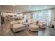 Open-concept living space with hardwood floors, a sectional sofa, and an adjacent kitchen and dining area at 688 Saffron Blvd, Lawrenceville, GA 30045