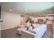 Bright living room featuring a large sectional sofa, hardwood floors, and an open layout to the kitchen at 688 Saffron Blvd, Lawrenceville, GA 30045