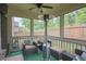 Enjoy an outdoor oasis with comfortable seating, a ceiling fan and heater, and views of a lush, fenced backyard at 688 Saffron Blvd, Lawrenceville, GA 30045
