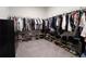 Spacious walk-in closet featuring ample storage with shelving and hanging rods for clothes and accessories at 688 Saffron Blvd, Lawrenceville, GA 30045