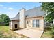 Backyard patio on a beige house with a gray roof and white chimney at 7270 Williamsburg Dr, Riverdale, GA 30274