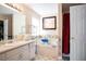 Bright bathroom featuring a soaking tub, a separate shower, and vanity with ample counter space at 7270 Williamsburg Dr, Riverdale, GA 30274