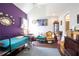 Comfortable bedroom with a colorful accent wall, featuring seating and a mounted TV at 7270 Williamsburg Dr, Riverdale, GA 30274