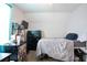 A bedroom with a bed, dresser, and a mini-fridge offering a private and comfortable living space at 7270 Williamsburg Dr, Riverdale, GA 30274
