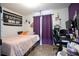 Bedroom featuring colorful decor, a comfortable bed, and ample space for relaxation and personal touches at 7270 Williamsburg Dr, Riverdale, GA 30274