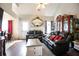 Bright living room featuring a vaulted ceiling, a decorative fireplace, hardwood floors, and comfortable leather seating at 7270 Williamsburg Dr, Riverdale, GA 30274
