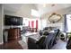 Bright living room with vaulted ceiling, decor fireplace, hardwood floors, and a large-screen television and leather seating at 7270 Williamsburg Dr, Riverdale, GA 30274