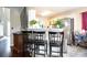 An open-concept living and dining area with hardwood floors, bar seating, and views to the kitchen at 7270 Williamsburg Dr, Riverdale, GA 30274
