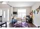 A living room featuring colorful wall art, hardwood floors, and a doorway to an adjacent room at 7270 Williamsburg Dr, Riverdale, GA 30274