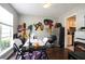 A dining room featuring colorful wall art, hardwood floors, and a view into the adjacent kitchen at 7270 Williamsburg Dr, Riverdale, GA 30274