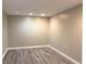 Spacious basement area with modern gray wood-look vinyl flooring and neutral colored walls at 3079 Colonial Way # J, Atlanta, GA 30341