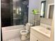 Modern bathroom featuring a tub-shower, gray tile surround, and stylish vanity and fixtures at 3079 Colonial Way # J, Atlanta, GA 30341