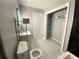 Cozy bathroom featuring modern fixtures, tile flooring, and an open closet at 3079 Colonial Way # J, Atlanta, GA 30341