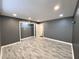Spacious bedroom features gray walls, modern lighting, wood-look vinyl flooring and a large closet at 3079 Colonial Way # J, Atlanta, GA 30341