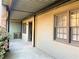 Side exterior view of property with covered patio and tan siding at 3079 Colonial Way # J, Atlanta, GA 30341