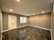 Inviting living room boasts dark tile floors, neutral paint, and a bright white front door at 3079 Colonial Way # J, Atlanta, GA 30341