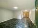 Open living room with green tile flooring, light gray walls, and an abundance of natural light at 3079 Colonial Way # J, Atlanta, GA 30341