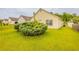 Rear view of home surrounded by lush green lawn and tidy shrubbery, creating a serene outdoor space at 3531 Brookstone Way, Union City, GA 30291
