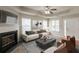 Inviting living room featuring a fireplace, ceiling fan, and a comfortable sofa with stylish decor at 3531 Brookstone Way, Union City, GA 30291
