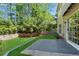 A beautiful backyard features a green lawn, a privacy fence, and a stone patio at 5010 Foxberry Ln, Roswell, GA 30075