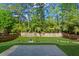 A landscaped backyard features a green lawn, a privacy fence, and a stone patio at 5010 Foxberry Ln, Roswell, GA 30075