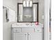 Well-lit bathroom with a large mirror and white cabinets at 5010 Foxberry Ln, Roswell, GA 30075