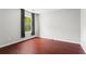 A bright bedroom features hardwood floors, natural light, and neutral walls at 5010 Foxberry Ln, Roswell, GA 30075