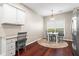 Sunny breakfast area features a table set for four and a built-in desk space at 5010 Foxberry Ln, Roswell, GA 30075