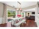 Bright dining area featuring hardwood floors, a white table with benches, and sliding glass doors to the backyard at 5010 Foxberry Ln, Roswell, GA 30075