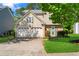 Charming home featuring a two-car garage, manicured lawn, and a welcoming front entrance at 5010 Foxberry Ln, Roswell, GA 30075