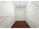 Spacious walk-in closet with plenty of shelving and hardwood floors at 5010 Foxberry Ln, Roswell, GA 30075