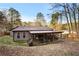 Well-maintained backyard featuring a covered patio, providing an ideal outdoor living space at 142 Old Hampton Way, Hampton, GA 30228