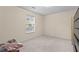 Bedroom featuring natural light from a window, complemented by neutral walls and carpeted flooring at 142 Old Hampton Way, Hampton, GA 30228