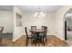 Cozy dining area featuring a round table with seating for four and a decorative chandelier at 142 Old Hampton Way, Hampton, GA 30228