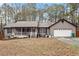 Charming ranch-style home with a covered front porch, attached two-car garage, and inviting curb appeal at 142 Old Hampton Way, Hampton, GA 30228