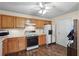 Functional kitchen with wood-look flooring, white appliances, and ample cabinet space at 142 Old Hampton Way, Hampton, GA 30228